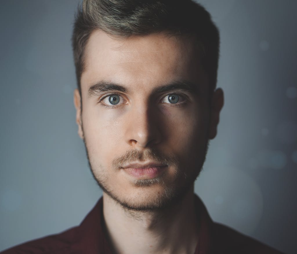 Close-up portrait of a young man with facial hair and a serious expression. Photographed by Hammer and Pixel - Hamilton Web Design & Digital Marketing Agency